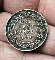 Reverse showing ONE CENT CANADA 1916 within maple leaf wreath