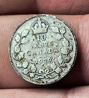 Reverse of 1929 Canada 10¢ showing crown, denomination, maple wreath, toning