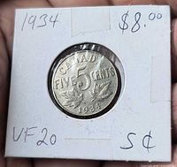 Reverse side showing denomination, date, maple leaves and handwritten details on flip