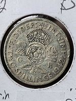 Reverse showing crowned rose, thistle, shamrock and date 1942