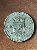 Reverse of 1961 one shilling coin showing Scottish shield, date and denomination