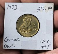 Coin reverse with owl design in holder