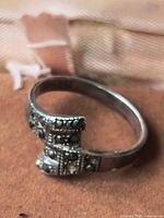 Side view of sterling silver marcasite ring showing missing stone and overall wear