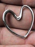 Front view of silver open heart pendant stamped 925