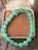 Bracelet in presentation box showing uniform green aventurine beads