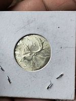 Reverse of 1968 Canadian 25-cent coin showing caribou, .500 silver, in 2×2 holder