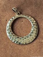Front view of open-circle hammered pendant