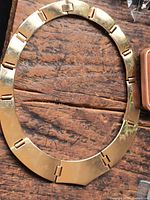 Full view of articulated plate necklace laid flat