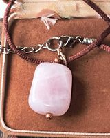 Rose quartz pendant with cord and clasp inside jewellery box