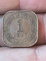 Reverse of 1943 Malaya square 1 cent coin showing denomination and date