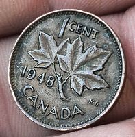 Reverse showing maple leaves, date 1948, CANADA legend, toning