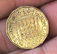 Reverse of 1965 UK three pence coin showing crowned portcullis and date