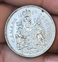 Reverse side showing Canadian coat of arms and date