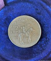 Reverse of coin showing mounted police design and denominations