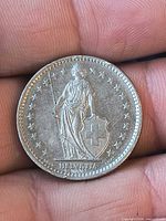 Obverse showing Helvetia figure with shield and spear, stars border