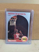 Front of 1989 NBA Hoops Akeem Olajuwon card in holder