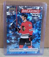 Front of Kevin Korchinski Breaking News holographic card in sleeve