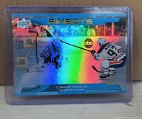 Front view of Connor McDavid Aimbots holographic card in holder