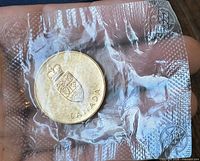 Obverse showing Canadian coat of arms and CANADA legend in sealed plastic