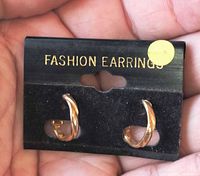 Front of earrings on card showing design and gold finish