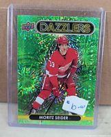 Front of Upper Deck DZ-67 Green Dazzlers card showing Moritz Seider in Red Wings uniform, in plastic holder