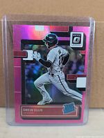 Card front showing pink holo design and Rated Rookie logo