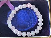 Bracelet displayed flat on dark background showing bead colour and shape