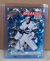 Front of Upper Deck Thatcher Demko Breaking News refractor card in sleeve