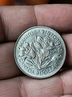 Reverse showing prairie crocus and dates 1870-1970 with CANADA DOLLAR legend