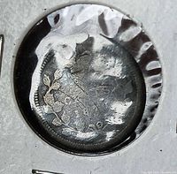 Obverse of holed 1870 Canadian 5 cent coin in flip