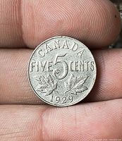 Reverse side showing CANADA FIVE CENTS 1929 with maple leaves