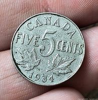 Reverse showing CANADA FIVE CENTS 1934 with maple leaves