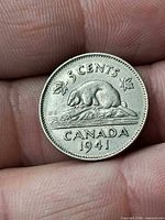 Reverse side of 1941 Canada 5 cent coin showing beaver, denomination and date