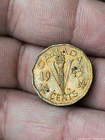 Reverse showing torch-V design, date 1943 and maple leaves