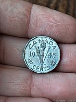 Reverse side with CANADA V torch design and 1945 date