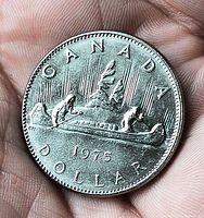 Reverse showing CANADA, 1974 date, DOLLAR legend, voyageur canoe design