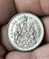 Reverse side of 1976 Canadian 50 cent coin showing coat of arms