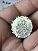 Reverse showing Canadian Coat of Arms, denomination and dates 1952-2002