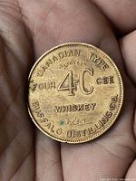 Obverse showing CANADIAN TYPE FOUR 4-C CEE WHISKEY BUFFALO DISTILLING CO. legends