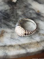 Full view of sterling silver ring on marble surface