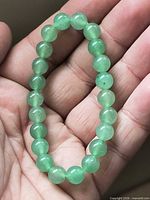 Bracelet resting on hand showing bead size and color