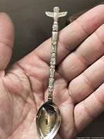Full view of spoon showing totem pole handle and bowl