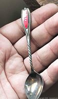 Full view of silver-plated Expo ’70 spoon in hand