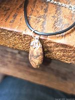 Close-up of jasper pendant on cord