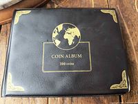 Front cover of black coin album marked 300 coins