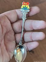 Front view showing enamel crest, handle detail, bowl