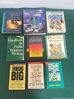 All nine books laid out showing fronts