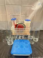 Group shot showing glass vases in front and plastic containers with lids
