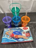 Full lot: Barbie box, four tumblers, one bucket cup