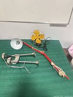 Lamp, horns and fan laid out on table